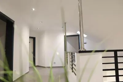 a hallway with white walls and a staircase at Rajske doline in Oćune