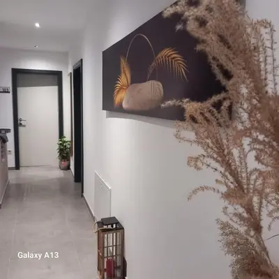 a hallway with a painting on the wall at Rajske doline in Oćune