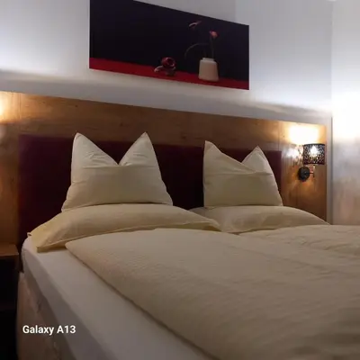 a large white bed with white pillows on it at Rajske doline in Oćune