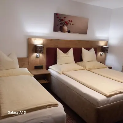 two beds in a hotel room with two beds at Rajske doline in Oćune