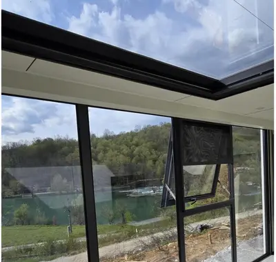 a window with a view of a lake at APPLE Cabin with Jacuzzi - Sauna in Drenova Glavica