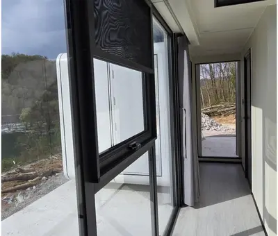 a door to a balcony with a view of the ocean at APPLE Cabin with Jacuzzi - Sauna in Drenova Glavica