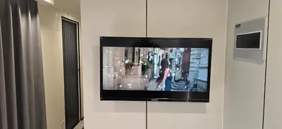 a flat screen tv on a wall in a room at APPLE Cabin with Jacuzzi - Sauna in Drenova Glavica
