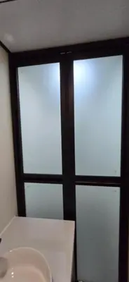 two windows in a room with a white table at APPLE Cabin with Jacuzzi - Sauna in Drenova Glavica