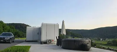 two refrigerators and an umbrella on the side of a road at APPLE Cabin with Jacuzzi - Sauna in Drenova Glavica