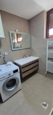 a bathroom with a washing machine and a sink at Center Heritage Two-bedroom Apartment in Teslić
