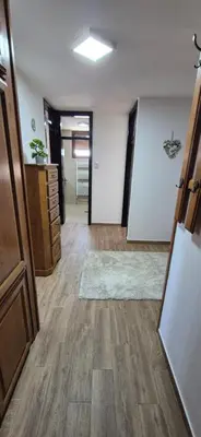 an empty room with a hallway with wooden floors at Center Heritage Two-bedroom Apartment in Teslić