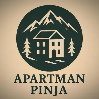 a logo of a building in front of a mountain at Apartman Pinja in Vlasic
