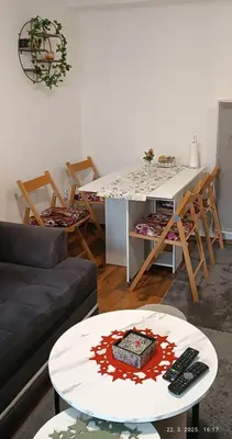 a living room with a couch and a table at Apartman Pinja in Vlasic