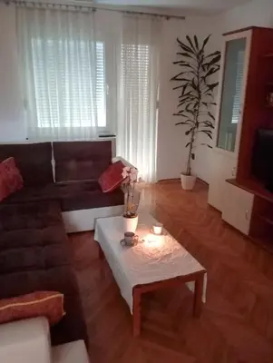 a living room with a couch and a coffee table at Apartman Doboj in Doboj