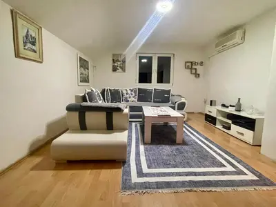 a living room with a couch and a table at Apartman Iman in Kulen Vakuf