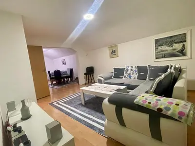 a living room with a couch and a table at Apartman Iman in Kulen Vakuf