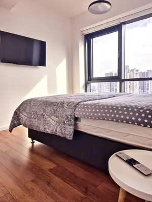a bedroom with a bed and a large window at Apartment Modern Nest in Zenica