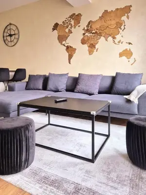 a living room with a blue couch with a coffee table at Apartment Modern Nest in Zenica