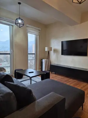 a living room with a couch and a flat screen tv at Apartment Modern Nest in Zenica