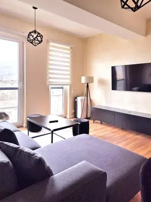 a living room with a couch and a flat screen tv at Apartment Modern Nest in Zenica