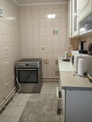 a kitchen with a stove top oven in a kitchen at apartman Sara in Tuzla