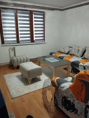 a living room with a couch and a table at apartman Sara in Tuzla