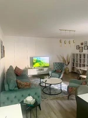a living room with a couch and a tv at Studio in Modriča
