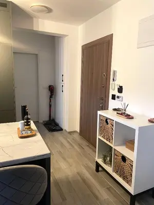 a living room with a white cabinet and a door at Studio in Modriča