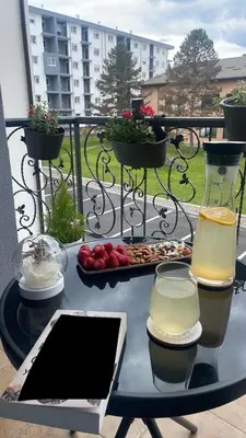 a table with a tray of food and two glasses of wine at Studio in Modriča
