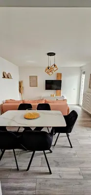 a living room with a table and chairs and a couch at Apartman Vrućica view in Teslić