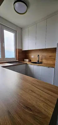 a kitchen with a wooden counter top and a sink at Apartman Vrućica view in Teslić