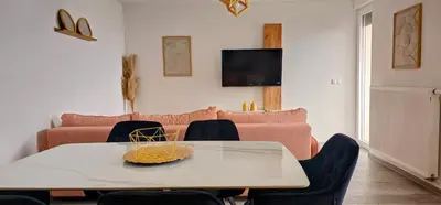a living room with a table and a couch at Apartman Vrućica view in Teslić