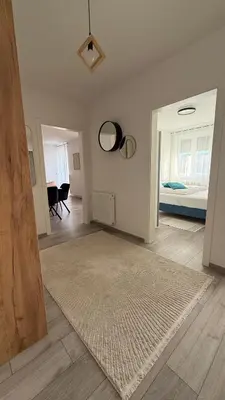 a living room with a rug and a bedroom at Apartman Vrućica view in Teslić
