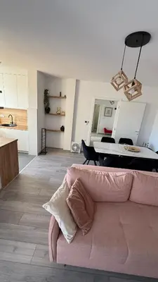 a living room with a pink couch and a table at Apartman Vrućica view in Teslić