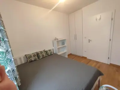 a small bedroom with a bed and a closet at Apartman Sedra in Bihać