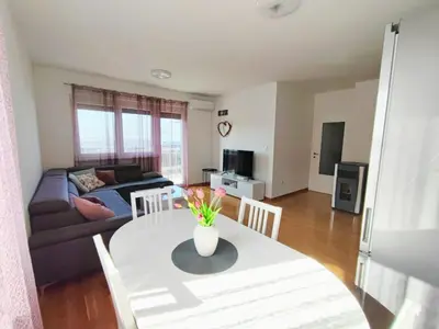 a living room with a table and a couch at Apartman Sedra in Bihać