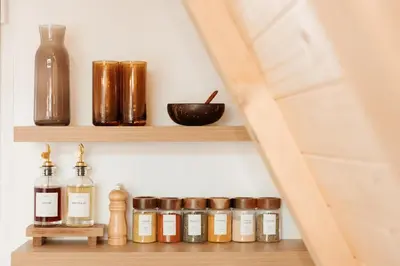 a shelf with bottles and jars on a wall at Hygge house in Banja Luka