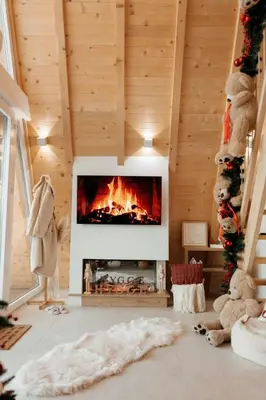 a living room with a fireplace in a wooden ceiling at Hygge house in Banja Luka
