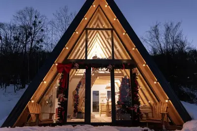a small house with a large window in the snow at Hygge house in Banja Luka