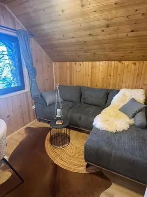 a living room with a couch and a table at Mountain Mia in Šišava