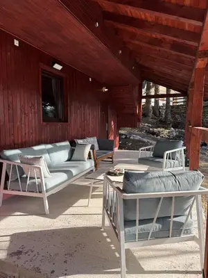 a living room with couches and chairs on a patio at Mountain Mia in Šišava