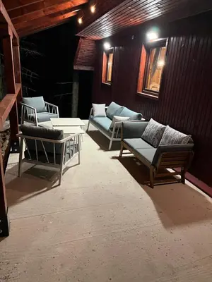 a group of chairs and couches on a patio at Mountain Mia in Šišava
