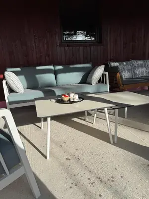 a living room with a couch and a table at Mountain Mia in Šišava