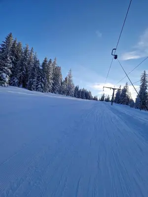 a snow covered field with a ski lift at Mountain Mia in Šišava