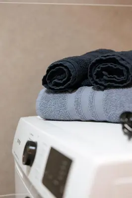 a stack of towels sitting on top of a washing machine at Vikendica miRAJ Manjaca in Gornje Ratkovo