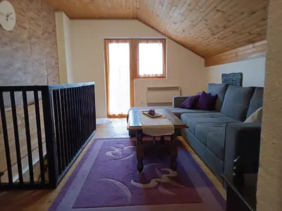 a living room with a couch and a table at Relaks dream in Vlasic