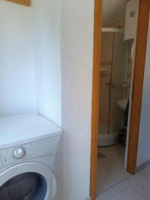 a bathroom with a washing machine in a room at Relaks dream in Vlasic