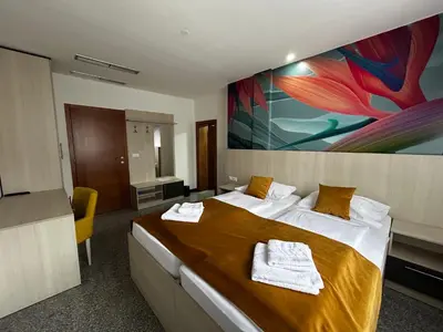 a hotel room with a bed and a painting on the wall at Prenoćište Euro-Jet Ćoralići in Ćoralići
