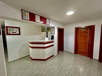 a lobby with a counter and a room with a door at Prenoćište Euro-Jet Ćoralići in Ćoralići
