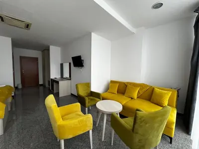 a living room with a yellow couch and yellow chairs at Prenoćište Euro-Jet Ćoralići in Ćoralići