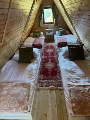 a room with three beds in a attic at Mountain Mia in Šišava