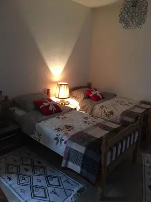 a bedroom with two beds and a lamp in it at Apartman Nafo in Bihać