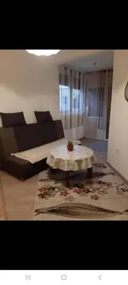 a living room with a couch and a table at Apartman Nafo in Bihać