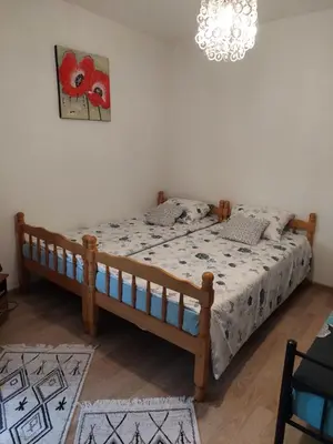 a bedroom with a bed in a room with a chandelier at Apartman Nafo in Bihać
